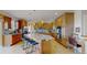 Spacious kitchen with granite countertops, wooden cabinetry, stainless steel appliances, and a central island at 1647 Harris Ct, Erie, CO 80516