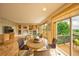 Open living room and dining area with fireplace, large windows and sliding doors to the deck at 1647 Harris Ct, Erie, CO 80516