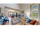 Bright living room featuring hardwood floors, tall ceilings, large windows, and adjacent dining room at 1647 Harris Ct, Erie, CO 80516