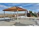 Community gazebo with picnic tables and playground in the background at 42984 Colonial Trl, Elizabeth, CO 80107