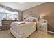 Cozy bedroom with a large window, neutral colors, and elegant furnishings at 10056 W Unser Dr # 102, Littleton, CO 80127