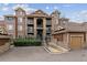 Inviting brownstone apartment building featuring multi-level balconies and convenient garage parking at 10056 W Unser Dr # 102, Littleton, CO 80127