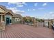 Large deck with scenic views overlooking townhouses with stone accents on the front and black railings at 10056 W Unser Dr # 102, Littleton, CO 80127
