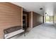 Exterior hallway leading to unit 102 and a wrought-iron bench for waiting at 10056 W Unser Dr # 102, Littleton, CO 80127