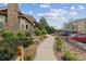 Landscaped walkway leading to building with stone and lush greenery at 10056 W Unser Dr # 102, Littleton, CO 80127