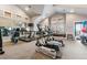 Well-equipped gym with treadmills, elliptical machines and weights in a bright space with a vaulted ceiling at 10056 W Unser Dr # 102, Littleton, CO 80127