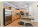 Well-appointed kitchen with stainless steel appliances, tile floors, and granite countertops at 10056 W Unser Dr # 102, Littleton, CO 80127