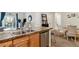 Kitchen island features granite countertop, stainless dishwasher, and double sink at 10056 W Unser Dr # 102, Littleton, CO 80127