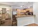Modern kitchen featuring stainless steel appliances, granite countertops, and warm wooden cabinetry at 10056 W Unser Dr # 102, Littleton, CO 80127