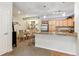 Eat-in kitchen with stainless steel appliances, granite countertops, and barstool seating at 10056 W Unser Dr # 102, Littleton, CO 80127