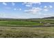 Expansive land offers stunning views of the valley and distant mountains on a sunny day at 10056 W Unser Dr # 102, Littleton, CO 80127