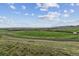 Scenic land offering beautiful views of the valley and distant mountains under a bright, cloudy sky at 10056 W Unser Dr # 102, Littleton, CO 80127