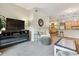 Open-concept living room with a fireplace, plush seating, and stylish decor at 10056 W Unser Dr # 102, Littleton, CO 80127