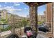 Stone pillar supporting a covered patio with outdoor seating and views of the community at 10056 W Unser Dr # 102, Littleton, CO 80127