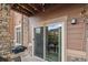 Sliding glass doors open to a covered patio with grill at 10056 W Unser Dr # 102, Littleton, CO 80127