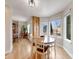 Sunlit breakfast nook with wood floors and large windows offers a pleasant dining experience at 14711 Detroit Way, Thornton, CO 80602