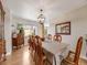 Formal dining room with wood floors, chandelier, and elegant table setting, perfect for Gathering gatherings at 14711 Detroit Way, Thornton, CO 80602