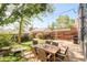 Outdoor wooden patio dining area with backyard, fence, and lush greenery at 277 S Gilpin St, Denver, CO 80209