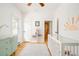 Bedroom room with hardwood floors, mint green dresser, crib, and decorative sun decal at 277 S Gilpin St, Denver, CO 80209