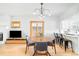 Dining area featuring a modern chandelier and an open view to the kitchen at 277 S Gilpin St, Denver, CO 80209