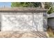 Detached garage with a white door and grey trim at 277 S Gilpin St, Denver, CO 80209