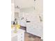 Kitchen with stainless steel appliances, white cabinets, and colorful tiled floor at 277 S Gilpin St, Denver, CO 80209