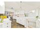 Bright kitchen with stainless steel appliances, white cabinets, colorful tiled floor, and staircase at 277 S Gilpin St, Denver, CO 80209
