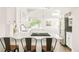Bright kitchen features skylight, white cabinets, island with seating and stainless steel appliances at 277 S Gilpin St, Denver, CO 80209