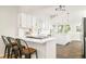Modern kitchen with white cabinets, sleek countertops, and a bar with seating at 277 S Gilpin St, Denver, CO 80209