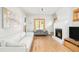 Bright living room featuring hardwood floors, a fireplace, and neutral tones at 277 S Gilpin St, Denver, CO 80209