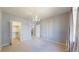 Spacious bedroom with a chandelier, a walk-in closet, and neutral carpeting at 5320 Allison St # 202, Arvada, CO 80002