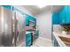 Bright, modern kitchen featuring stainless steel appliances and stylish blue cabinets for a contemporary feel at 5320 Allison St # 202, Arvada, CO 80002