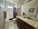 Bathroom with granite countertop vanity and shower-tub combo with tile surround at 14545 Barksdaly Way, Keenesburg, CO 80643