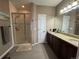 Bathroom featuring a glass enclosed shower, neutral color palette, and granite countertop vanity at 14545 Barksdaly Way, Keenesburg, CO 80643