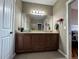 This bathroom is well-lit and features granite countertops and vanity with a neutral color scheme at 14545 Barksdaly Way, Keenesburg, CO 80643