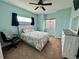 Bright bedroom featuring soft blue walls, natural light, and neutral carpet flooring at 14545 Barksdaly Way, Keenesburg, CO 80643