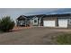 View of this single Gathering home with a two-car garage, gravel driveway, and tasteful light blue siding at 14545 Barksdaly Way, Keenesburg, CO 80643