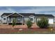 Charming single-story home featuring a mix of siding and brick, manicured landscaping, and an attached two car garage at 14545 Barksdaly Way, Keenesburg, CO 80643