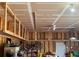 Garage with exposed beams, ceiling fan, and ample storage space for bikes and equipment at 14545 Barksdaly Way, Keenesburg, CO 80643