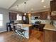 This kitchen features brown cabinets, stainless steel appliances, and granite countertops, offering both style and functionality at 14545 Barksdaly Way, Keenesburg, CO 80643