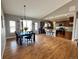 Open concept kitchen and dining area featuring wood floors, modern appliances, and access to outdoor space at 14545 Barksdaly Way, Keenesburg, CO 80643