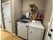 Convenient laundry room featuring a modern washer and dryer, and overhead shelving at 14545 Barksdaly Way, Keenesburg, CO 80643
