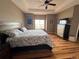 The main bedroom has wood floors, tray ceiling, ceiling fan, and large window to let in plenty of light at 14545 Barksdaly Way, Keenesburg, CO 80643