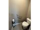 Powder room with hand rail, modern toilet and neutral color palette at 14545 Barksdaly Way, Keenesburg, CO 80643