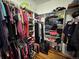 A second view of the walk-in closet with hanging clothes and storage at 14545 Barksdaly Way, Keenesburg, CO 80643