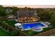 Beautifully landscaped backyard with a pool, lounge chairs, fire pit, and an outdoor kitchen at 3749 White Bay Dr, Highlands Ranch, CO 80126