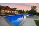 Stunning backyard featuring a pool, hot tub, fire pit, and outdoor dining, perfect for entertainment at 3749 White Bay Dr, Highlands Ranch, CO 80126
