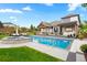 Beautiful backyard featuring a pool, hot tub, lounge chairs, and a covered patio for entertaining at 3749 White Bay Dr, Highlands Ranch, CO 80126