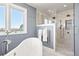 The bathroom is spacious and bright, featuring a standalone tub and glass shower at 3749 White Bay Dr, Highlands Ranch, CO 80126