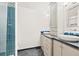 Modern bathroom featuring double sinks, beautiful tile work, and a glass-enclosed shower at 3749 White Bay Dr, Highlands Ranch, CO 80126